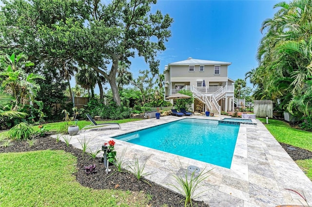 8963 Fishermens Bay Dr, Sarasota, FL 34231 - view of swimming pool with stairway, a patio, and a pool with connected hot tub