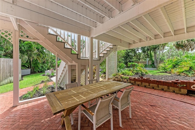 8963 Fishermens Bay Dr, Sarasota, FL 34231 - view of patio featuring stairway and outdoor dining area