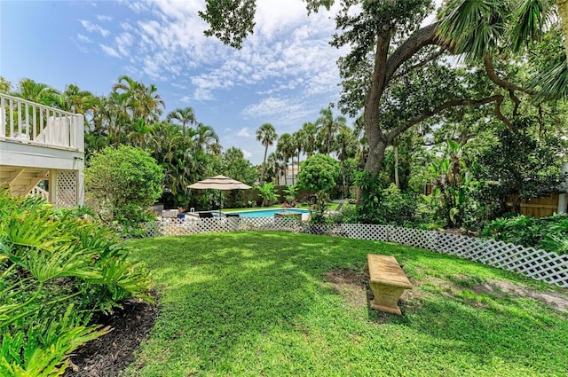 8963 Fishermens Bay Dr, Sarasota, FL 34231 - view of green lawn featuring a deck