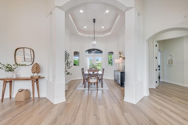 800 NW 36th Ave, Cape Coral, FL 33993 - dining area featuring arched walkways, light wood-style floors, a raised ceiling, baseboards, and recessed lighting