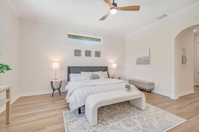 800 NW 36th Ave, Cape Coral, FL 33993 - bedroom with arched walkways, ornamental molding, light wood-style flooring, baseboards, and ceiling fan