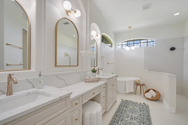 800 NW 36th Ave, Cape Coral, FL 33993 - full bathroom featuring a freestanding tub, double vanity, and walk in shower