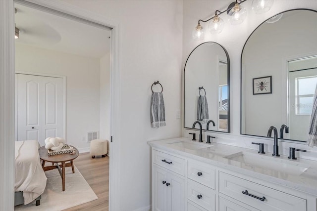 800 NW 36th Ave, Cape Coral, FL 33993 - bathroom with double vanity, wood finished floors, and baseboards
