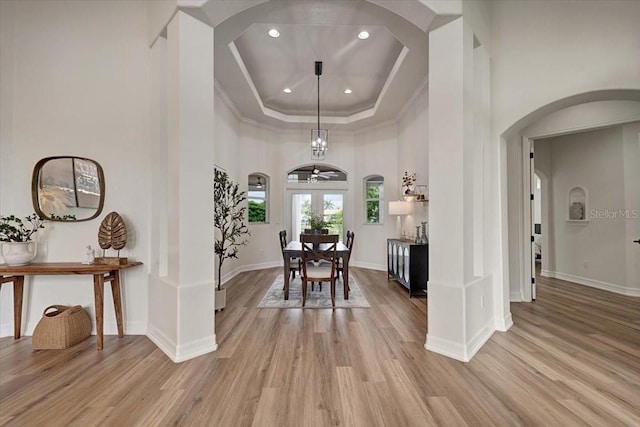 800 NW 36th Ave, Cape Coral, FL 33993 - dining space with arched walkways, light wood-type flooring, a tray ceiling, crown molding, and recessed lighting