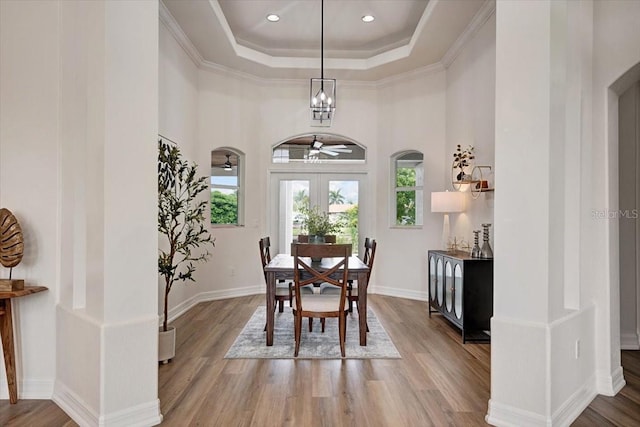 800 NW 36th Ave, Cape Coral, FL 33993 - dining area with wood finished floors, a raised ceiling, arched walkways, a chandelier, and a towering ceiling