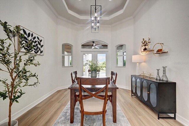 800 NW 36th Ave, Cape Coral, FL 33993 - dining area with a raised ceiling, light wood-style floors, ornamental molding, baseboards, and a chandelier