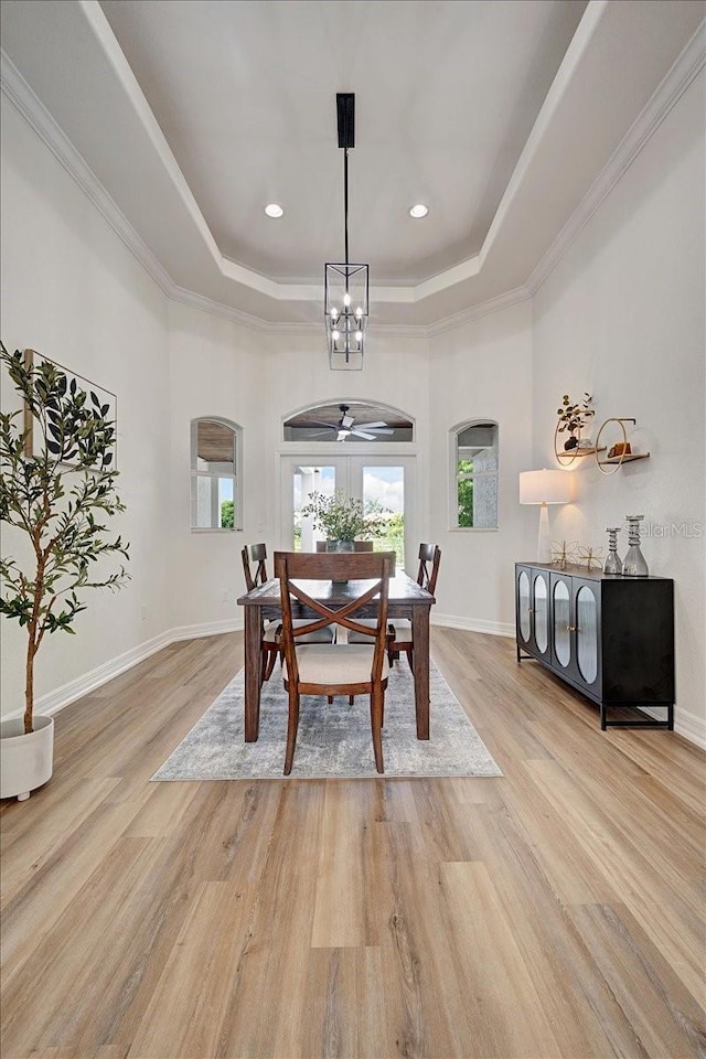 800 NW 36th Ave, Cape Coral, FL 33993 - dining room with a raised ceiling, a chandelier, light wood-style floors, baseboards, and ornamental molding