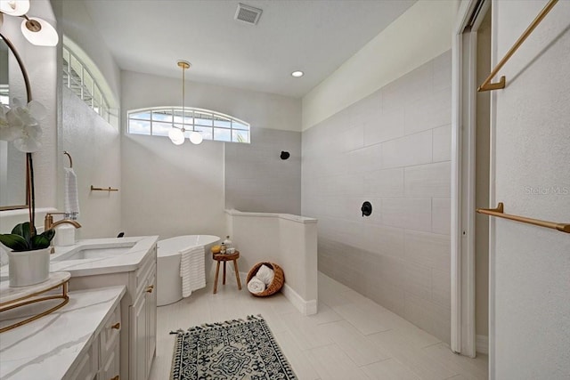 800 NW 36th Ave, Cape Coral, FL 33993 - full bathroom with vanity, walk in shower, a soaking tub, and recessed lighting