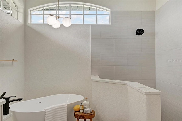 800 NW 36th Ave, Cape Coral, FL 33993 - full bath featuring a freestanding bath, plenty of natural light, a walk in shower, and a chandelier