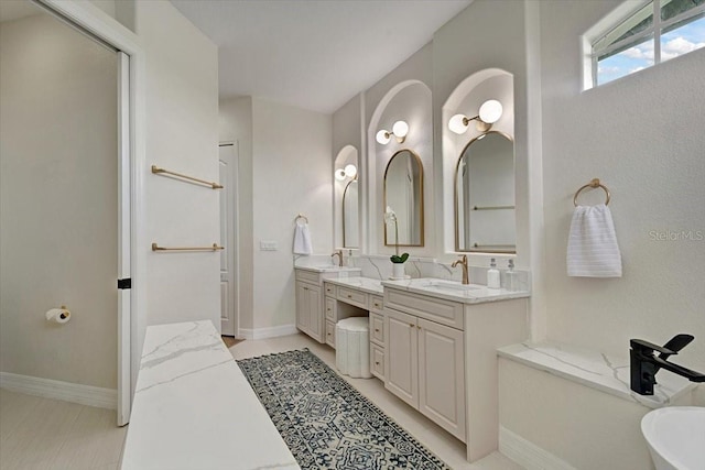 800 NW 36th Ave, Cape Coral, FL 33993 - full bath with vanity, a freestanding bath, and baseboards