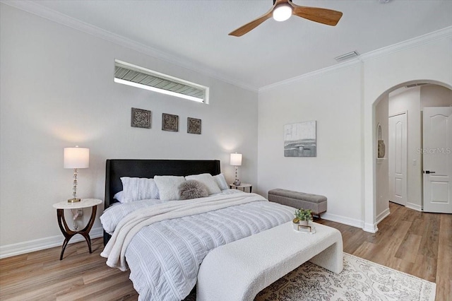 800 NW 36th Ave, Cape Coral, FL 33993 - bedroom with arched walkways, crown molding, light wood-type flooring, baseboards, and a ceiling fan