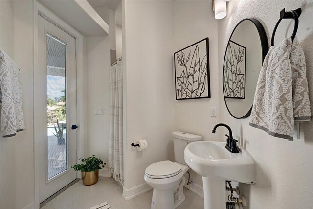 800 NW 36th Ave, Cape Coral, FL 33993 - bathroom featuring toilet and baseboards