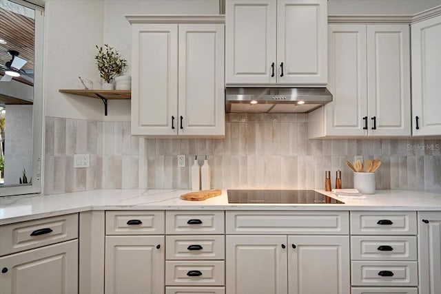 800 NW 36th Ave, Cape Coral, FL 33993 - kitchen with black electric cooktop, white cabinets, and under cabinet range hood