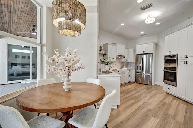800 NW 36th Ave, Cape Coral, FL 33993 - dining area featuring light wood-style floors, recessed lighting, a chandelier, and ceiling fan