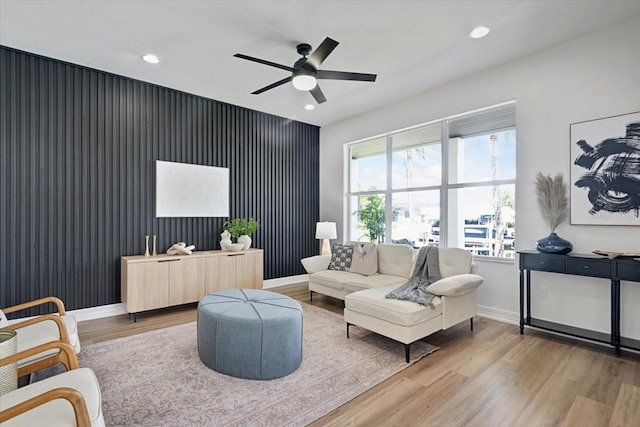 800 NW 36th Ave, Cape Coral, FL 33993 - living room with wood finished floors, an accent wall, ceiling fan, baseboards, and recessed lighting