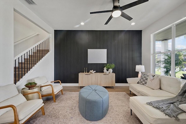 800 NW 36th Ave, Cape Coral, FL 33993 - living room featuring light wood-style flooring, recessed lighting, ceiling fan, an accent wall, and stairs