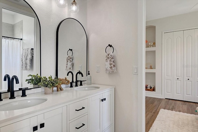 800 NW 36th Ave, Cape Coral, FL 33993 - full bathroom featuring double vanity, wood finished floors, a closet, and built in features