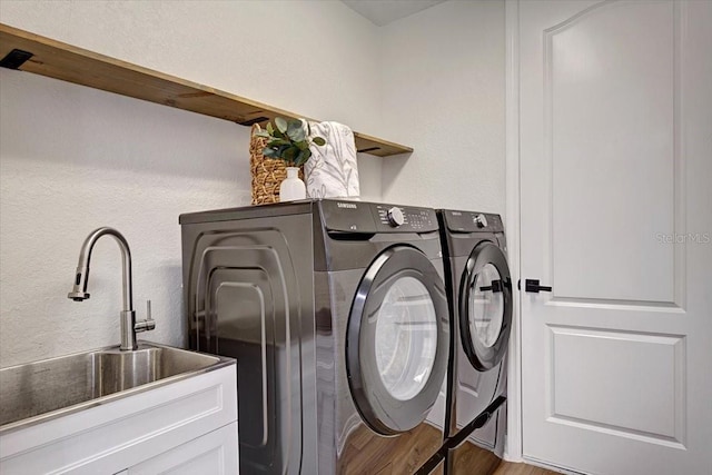 800 NW 36th Ave, Cape Coral, FL 33993 - laundry room with independent washer and dryer, wood finished floors, cabinet space, and a textured wall