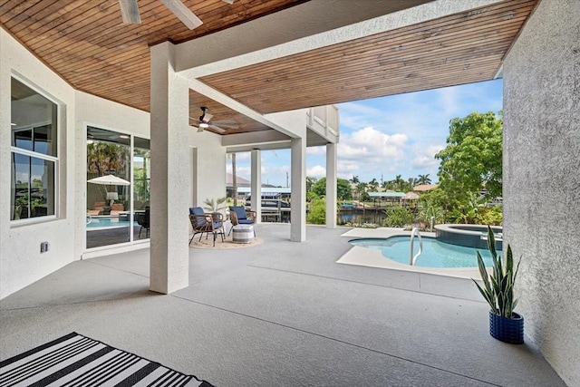 800 NW 36th Ave, Cape Coral, FL 33993 - view of pool with a ceiling fan, a patio, a pool with connected hot tub, and a water view