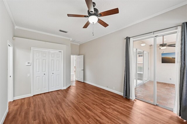 6744 Hickory Hammock Cir, Bradenton, FL 34202 - unfurnished bedroom featuring crown molding, wood finished floors, baseboards, and ceiling fan