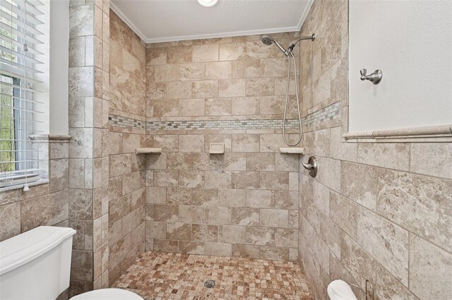 6744 Hickory Hammock Cir, Bradenton, FL 34202 - bathroom with toilet, a tile shower, crown molding, and tile walls