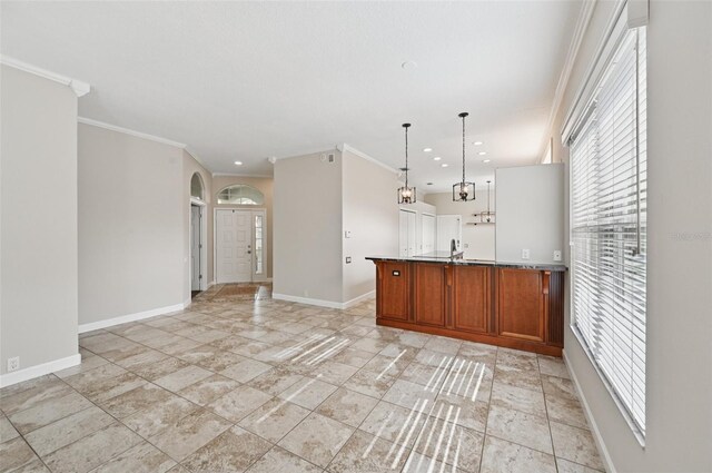 6744 Hickory Hammock Cir, Bradenton, FL 34202 - kitchen with brown cabinets, baseboards, a peninsula, decorative light fixtures, and recessed lighting