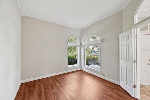 6744 Hickory Hammock Cir, Bradenton, FL 34202 - spare room with crown molding, wood finished floors, and baseboards