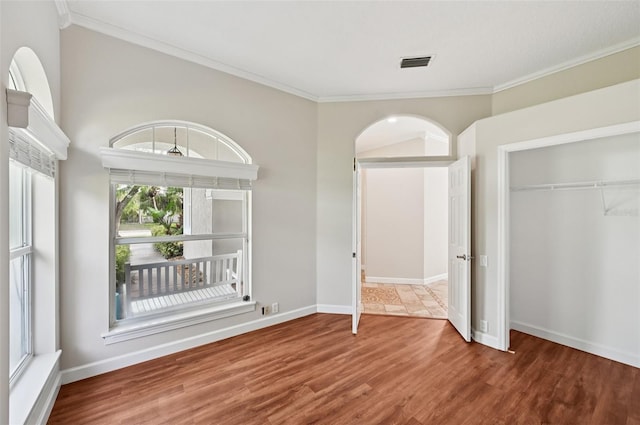 6744 Hickory Hammock Cir, Bradenton, FL 34202 - unfurnished bedroom with wood finished floors, crown molding, a closet, and baseboards