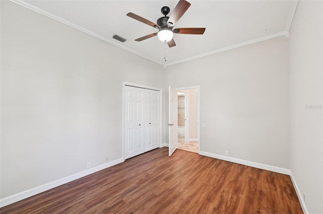 6744 Hickory Hammock Cir, Bradenton, FL 34202 - unfurnished bedroom featuring ornamental molding, baseboards, wood finished floors, a closet, and a ceiling fan