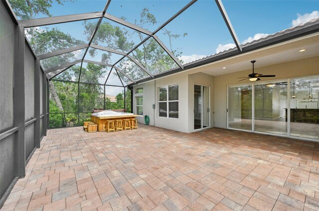 6744 Hickory Hammock Cir, Bradenton, FL 34202 - view of patio / terrace featuring a lanai, a hot tub, and a ceiling fan