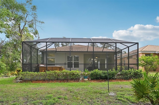6744 Hickory Hammock Cir, Bradenton, FL 34202 - back of house featuring a hot tub, a yard, stucco siding, and glass enclosure