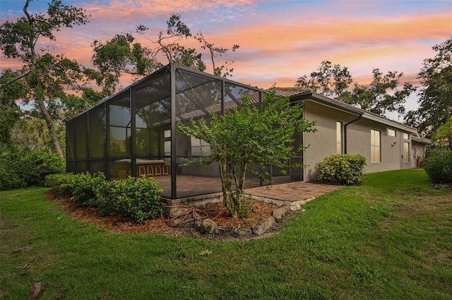 6744 Hickory Hammock Cir, Bradenton, FL 34202 - back of property featuring a patio, stucco siding, a lawn, and a tile roof