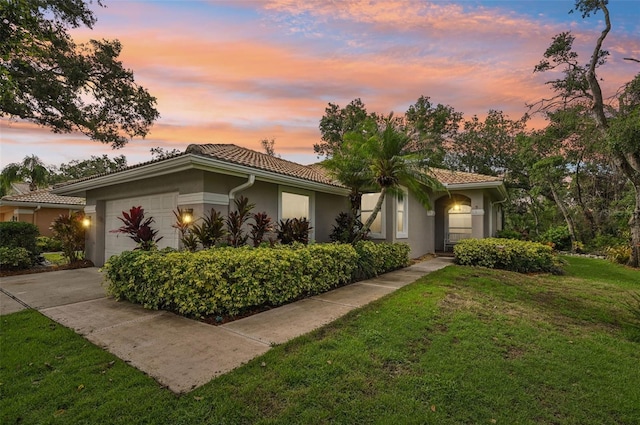 6744 Hickory Hammock Cir, Bradenton, FL 34202 - view of front of property with a garage, a front lawn, driveway, stucco siding, and a tiled roof