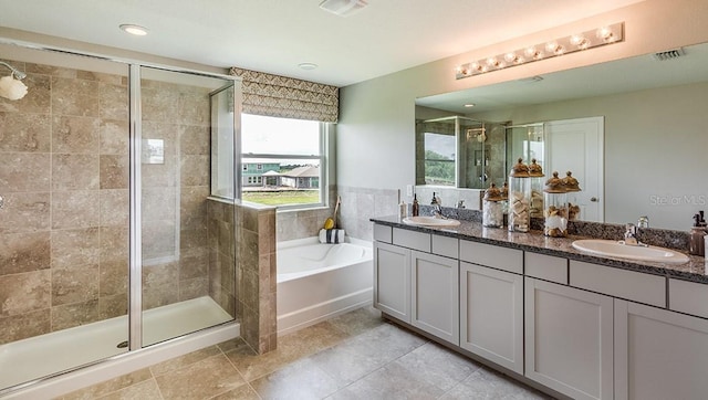 12051 Kingsley Trl, Parrish, FL 34219 - full bathroom featuring a bath, double vanity, a stall shower, tile patterned floors, and recessed lighting