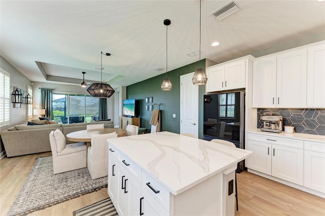 17898 Cherished Loop, Bradenton, FL 34211 - kitchen featuring light wood-style flooring, healthy amount of natural light, open floor plan, and recessed lighting