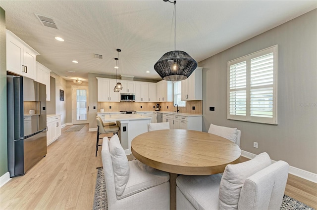 17898 Cherished Loop, Bradenton, FL 34211 - dining room with baseboards, healthy amount of natural light, light wood-style floors, and recessed lighting