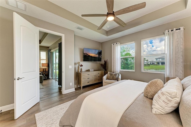 17898 Cherished Loop, Bradenton, FL 34211 - bedroom with wood finished floors, baseboards, a raised ceiling, and a ceiling fan