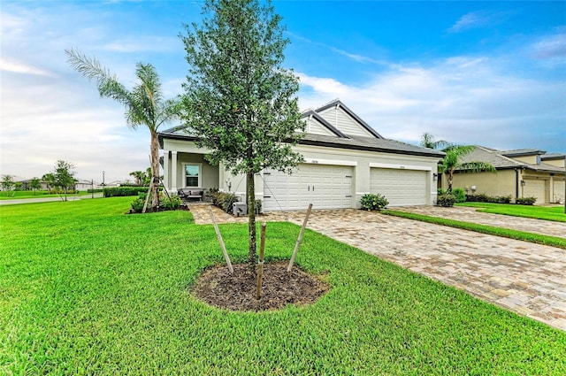 17898 Cherished Loop, Bradenton, FL 34211 - view of front of home with a front yard, decorative driveway, stucco siding, and a garage