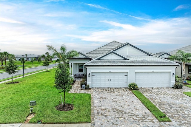 17898 Cherished Loop, Bradenton, FL 34211 - view of front of home with stucco siding, a front lawn, a garage, decorative driveway, and a tiled roof