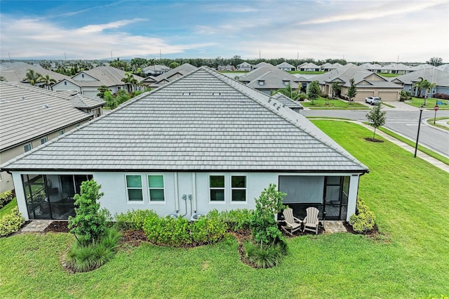 17898 Cherished Loop, Bradenton, FL 34211 - back of property with a sunroom, a residential view, and a lawn