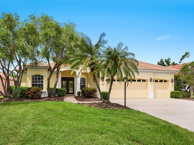 6811 Honeysuckle Trl, Lakewood Ranch, FL 34202 - mediterranean / spanish-style home featuring french doors, stucco siding, a garage, and concrete driveway