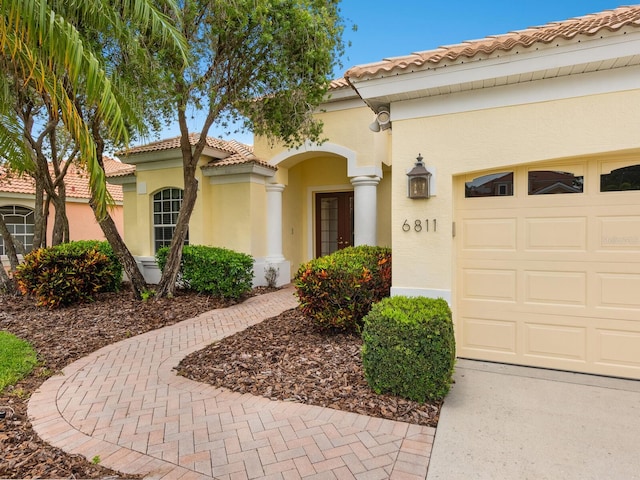 6811 Honeysuckle Trl, Lakewood Ranch, FL 34202 - mediterranean / spanish home with stucco siding, a tile roof, and an attached garage