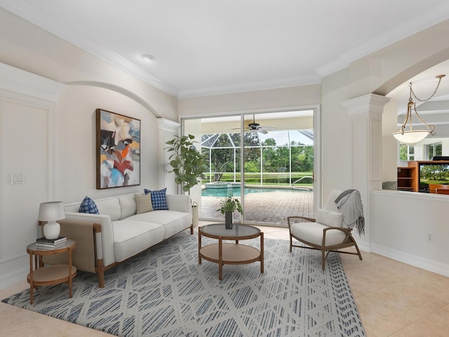 6811 Honeysuckle Trl, Lakewood Ranch, FL 34202 - living area with a sunroom, crown molding, light tile patterned floors, arched walkways, and ornate columns