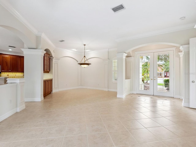 6811 Honeysuckle Trl, Lakewood Ranch, FL 34202 - unfurnished living room featuring light tile patterned floors, french doors, crown molding, and arched walkways
