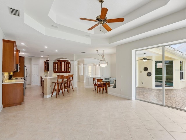 6811 Honeysuckle Trl, Lakewood Ranch, FL 34202 - dining area featuring recessed lighting, a ceiling fan, light tile patterned floors, and a raised ceiling