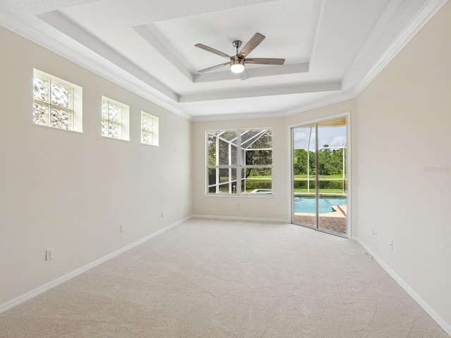 6811 Honeysuckle Trl, Lakewood Ranch, FL 34202 - empty room featuring a raised ceiling, light carpet, ceiling fan, and crown molding