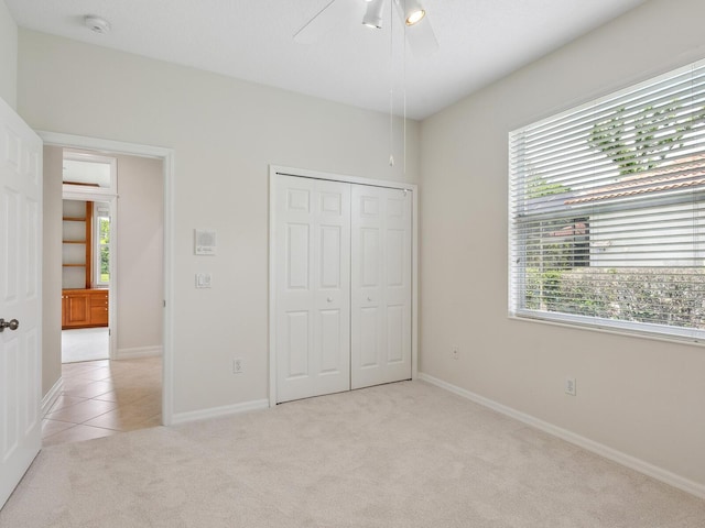 6811 Honeysuckle Trl, Lakewood Ranch, FL 34202 - unfurnished bedroom with multiple windows, light carpet, a closet, and a ceiling fan