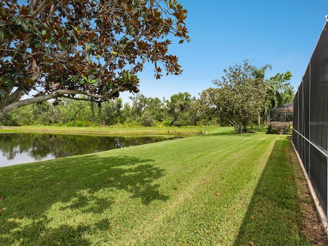 6811 Honeysuckle Trl, Lakewood Ranch, FL 34202 - view of green lawn featuring a water view and a lanai