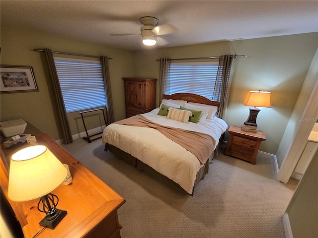 1211 Capri Isles Blvd Unit 116, Venice, FL 34292 - bedroom with light colored carpet, baseboards, and a ceiling fan
