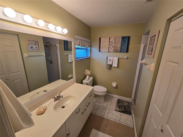 1211 Capri Isles Blvd Unit 116, Venice, FL 34292 - bathroom with a stall shower, vanity, a textured ceiling, toilet, and baseboards